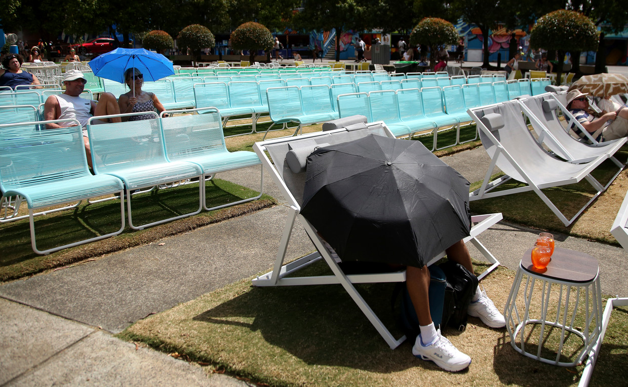 Spectators at the Australian Open protect themselves from the heat in Melbourne.  AP photo