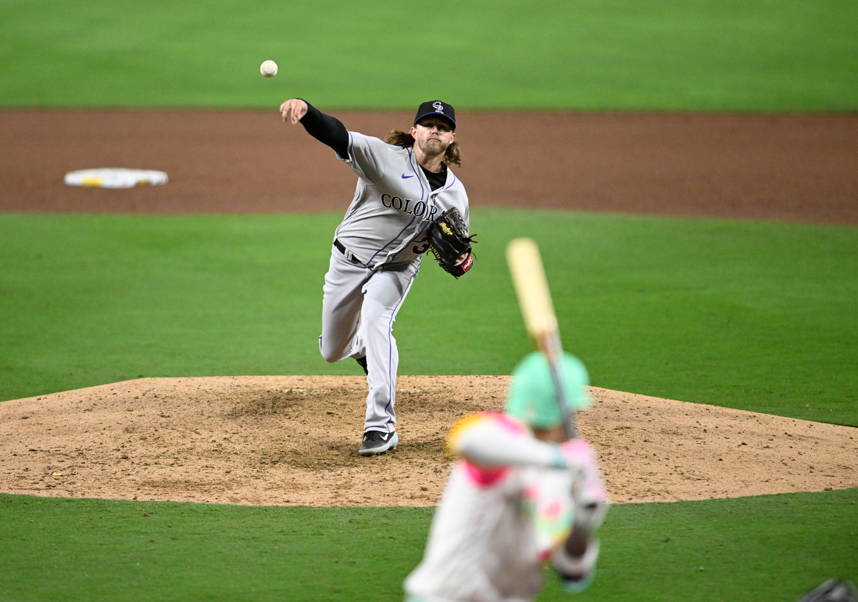 The Colorado Rockies' Pierce Johnson is on the pitcher's mound, with the San Diego Padres' Manny Machado at bat.  During preparation, Machado was the first player to receive an automatic strike because he was not ready in time.  Getty Image